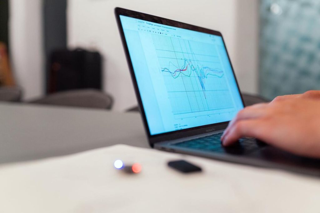 laptop screen showing a line chart of website traffic on a clean desk, daylight, no people