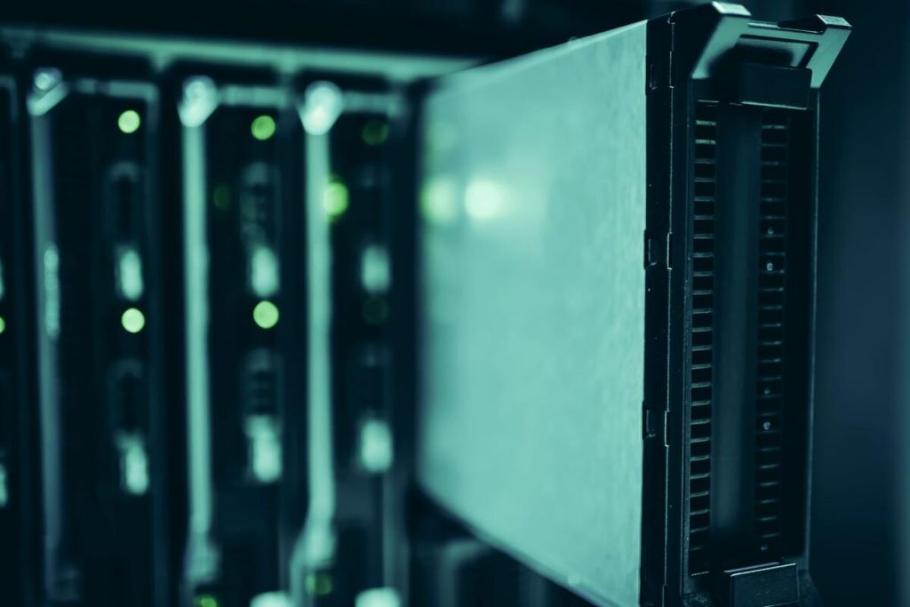 close-up of a server rack with green status lights in a quiet data room, no people