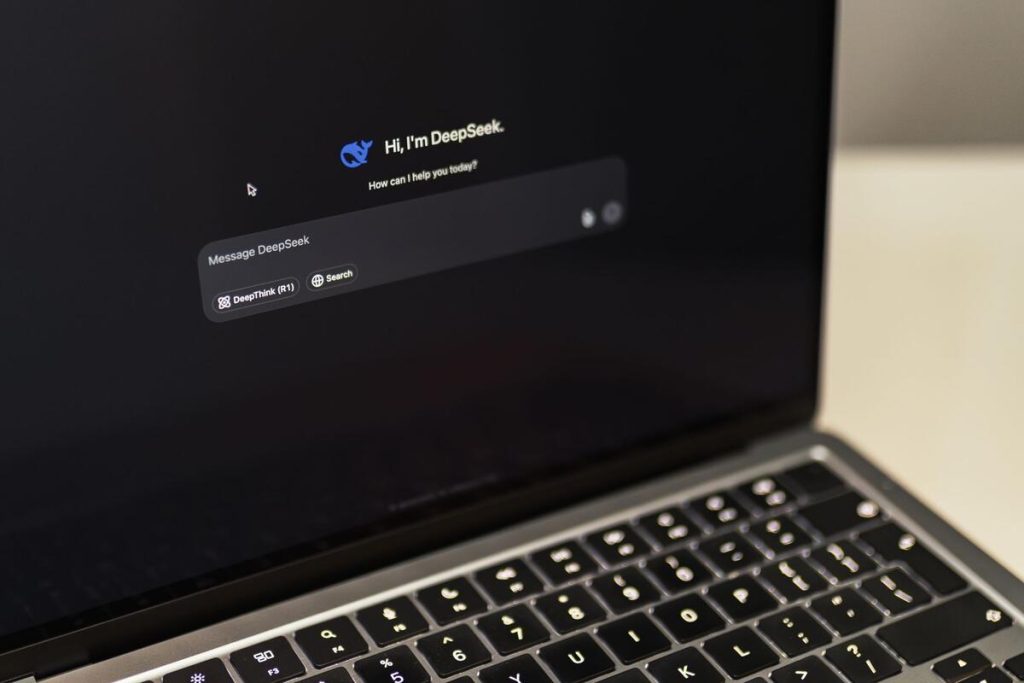 AI chatbot interface on laptop screen with code in background, no people