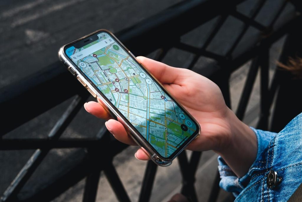 smartphone screen showing a map pin for a local business on a city street, no people, no text