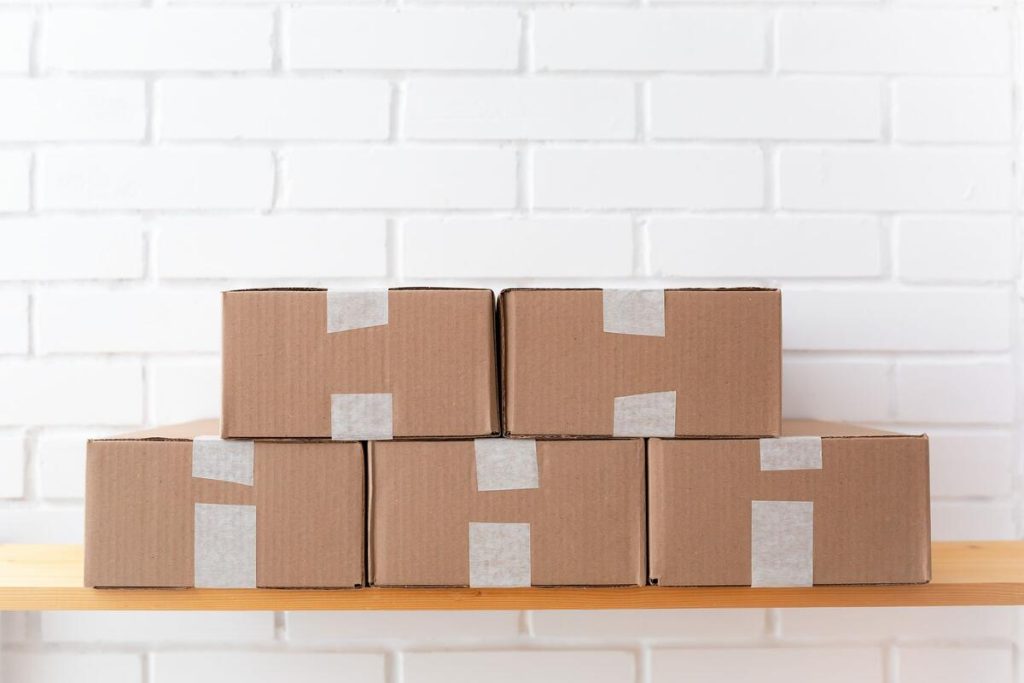 cardboard delivery boxes stacked in a warehouse, online shopping theme