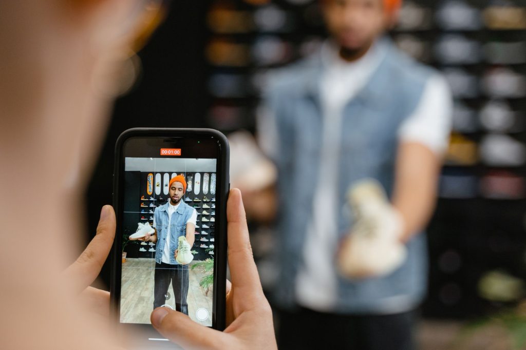 Smartphone screen showing a social media shopping feed with product photos, no visible faces