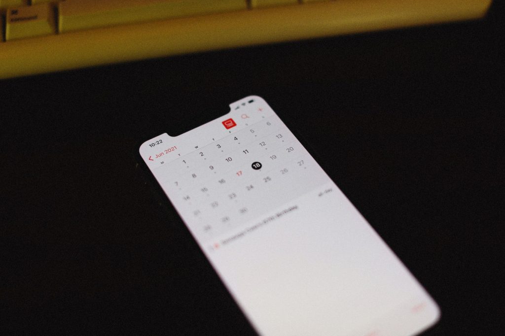 calendar page marked with Black Friday date next to a smartphone showing a shopping app, no people