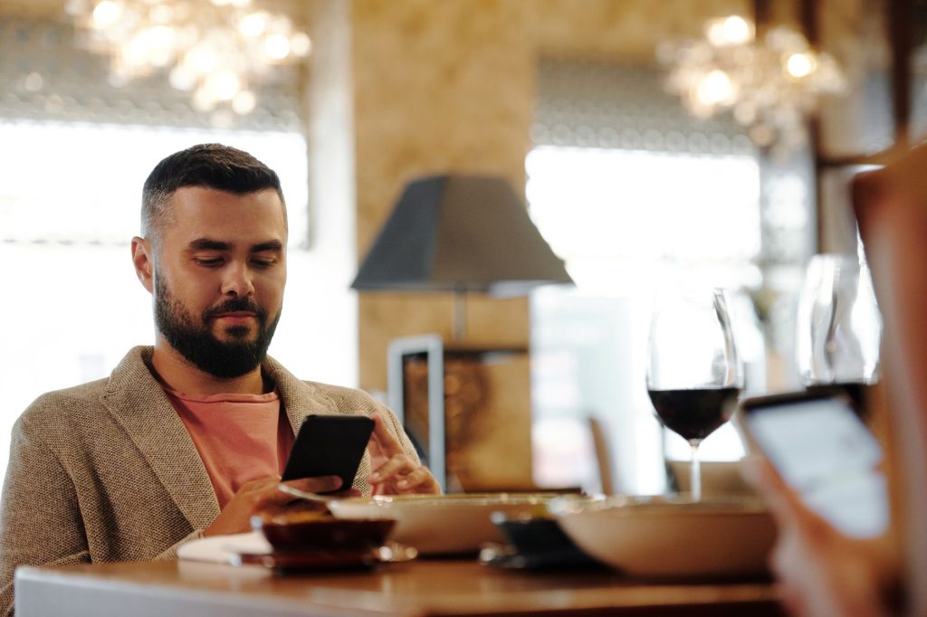 restaurant owner looking at phone screen with chat notification